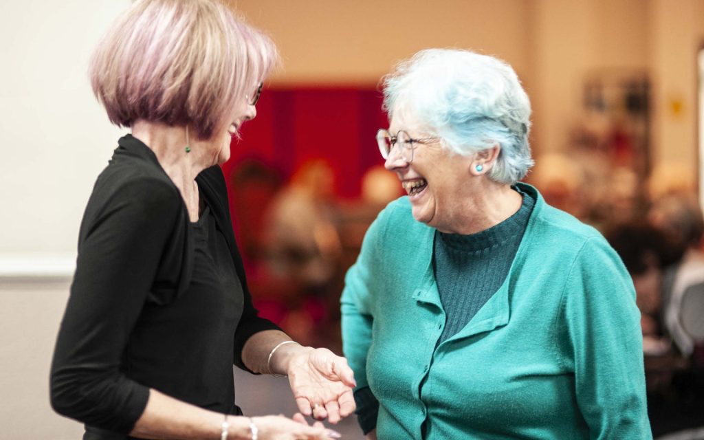 Two members laughing together